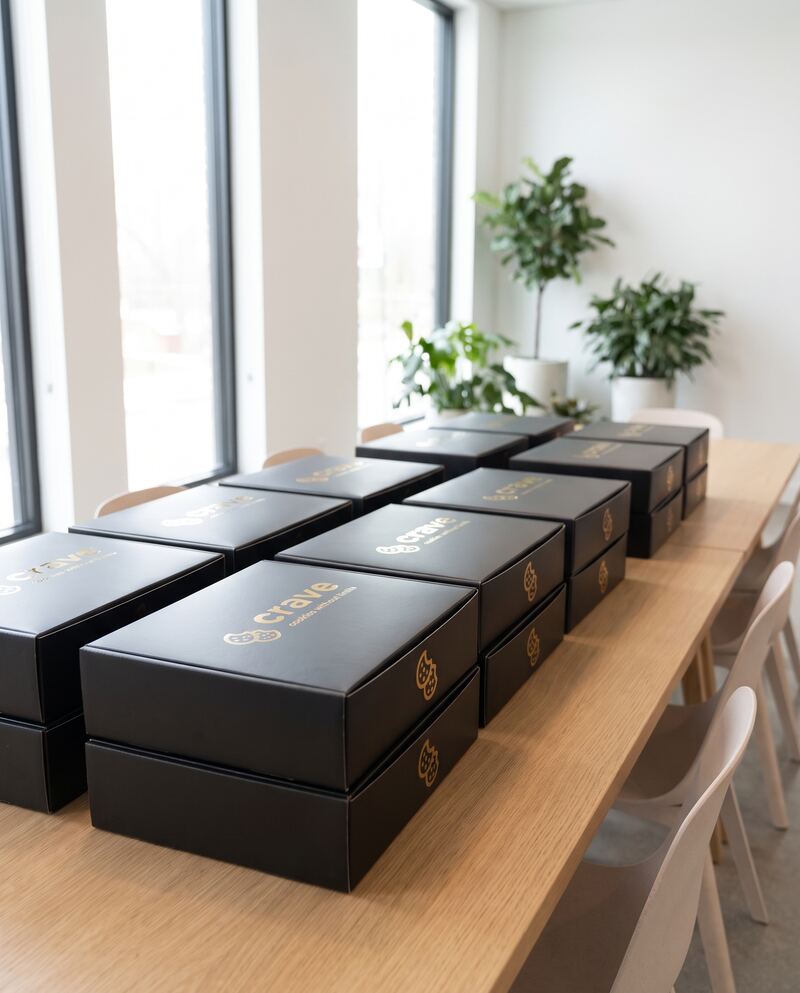 Rows of closed Crave boxes stacked along an event table