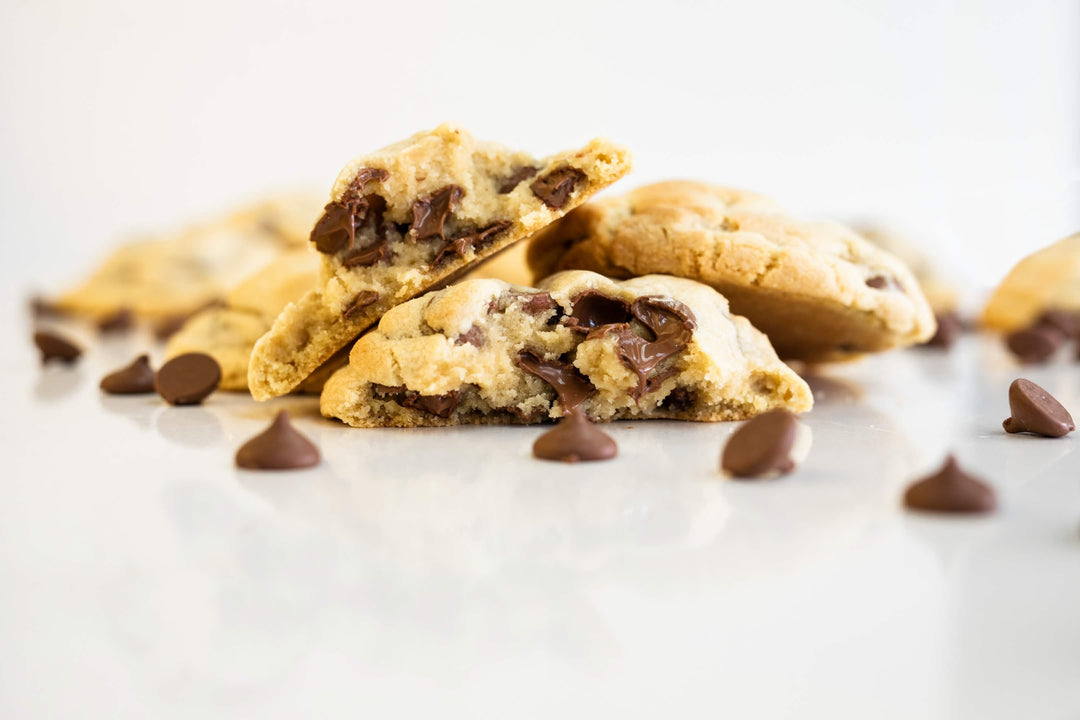 Crave chocolate chip cookies broken open with melted chocolate chips